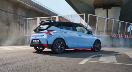 Rear view of a blue Hyundai i20 N in a carpark