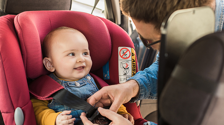 Putting on seatbelt for baby