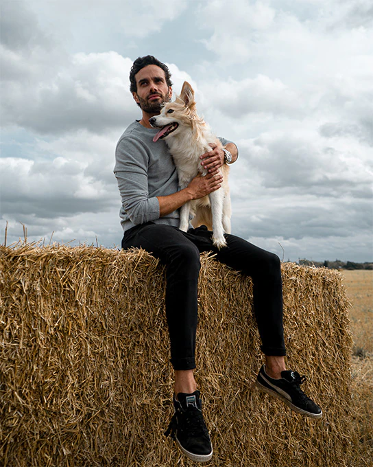 James Dunmore sitting on a bale of hay