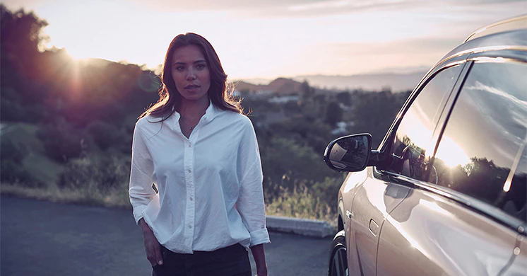 Woman posing in front of a hyundai vehicle